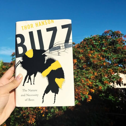 Hand holding book called Buzz